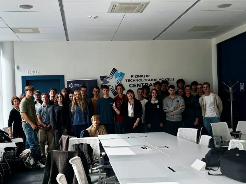 Group photo with the students and their teachers in front of the Center for Physical Sciences and Technology logo